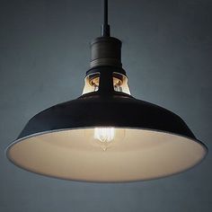 a black and white light hanging from a ceiling