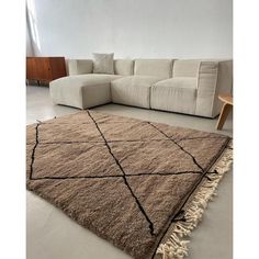 a living room with a couch and rug on the floor