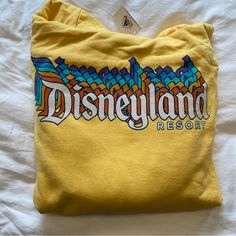 Disneyland Parks Resort Yellow Gold Vintage Design Sweatshirt With Hood And Ties And Neck Purchased From Disneyland Vintage Disney Hoodie, Trendy Yellow Tops With Logo Print, Yellow Letter Print Crew Neck Hoodie, Yellow Crew Neck Hoodie With Letter Print, Trendy Yellow Sweatshirt With Letter Print, Trendy Yellow Crew Neck Sweatshirt, Retro Yellow Tops With Logo Print, Casual Yellow Crew Neck Hoodie, Yellow Cotton Crew Neck Hoodie