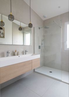 a bathroom with two sinks and a shower