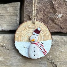 a wooden ornament with a snowman on it