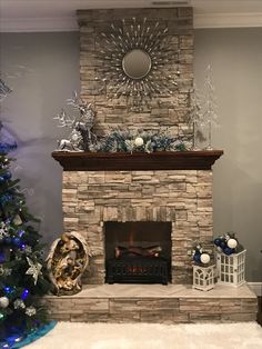 a living room decorated for christmas with a fire place and tree in front of the fireplace