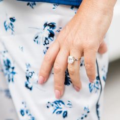 a close up of a person's hand with a ring on it