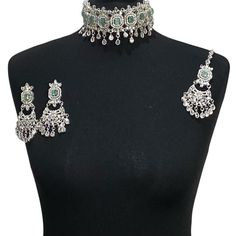 Handcrafted mint green silver Indian wedding / bridal choker jewellery set. Set includes- Earrings  Choker necklace Tikka  Our choker is adjustable with a dori at the back giving you a comfortable fit. It comes with elegant chandbali earrings with gem detail, tikka with hooks.  The glimmer of the gems with elegant diamonte detail make this jewelry set a truly head turning piece, a must have for every jewellery box.  Our ethnic jewellery set harmoniously blends the allure of Pakistani, Punjabi an Silver Kundan Choker As Gift, Silver Kundan Choker For Gift, Bohemian Green Bridal Necklace For Wedding, Silver Kundan Choker For Wedding, Silver Kundan Choker Necklace For Wedding, Silver Bridal Sets For Festivals, Green Wedding Choker Jewelry, Silver Kundan Choker Jewelry Sets, Green Kundan Choker Necklace For Wedding