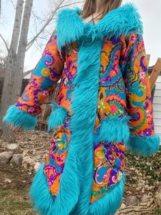 Crazy gorgeous Penny Lane Coat made with real vintage 1970s neon quilted paisley with a  turquoise mohair shag faux fur! Size is a small/medium womens. I am wearing it in the photos and am 5'9 140lb and it fits great but will be more snug for a medium and looser on small but can still be rocked by either. The measurements are: Shoulder to shoulder: 18.5 inch , Length: 43 inch, Waist: 38 inch, Sleeve: 26 inch. There are three buttons clasps with a braided elastic loop  closure. There are two hand pockets on the front as well as a inner secret pocket. There were two places where I had to repair the black stitching, not very noticeable but I did add a picture of one spot where you can slightly see it but it is very close to the bottom seam, keep in mind this fabric is 50 years old so it neede Fitted Turquoise Outerwear For Winter, Boho Fashion Winter, Faux Fur Fashion, Penny Lane Coat, Painted Clothes Diy, Cool Coats, Types Of Coats, Paisley Fabric, Painted Clothes