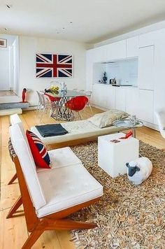 a living room filled with furniture and a union jack flag on the wall behind it