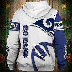 a white and blue hoodie with the rams logo on it, sitting against a wooden background