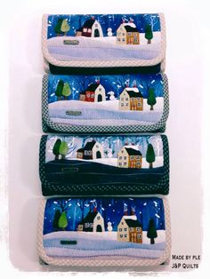 three wallets with houses and trees on them