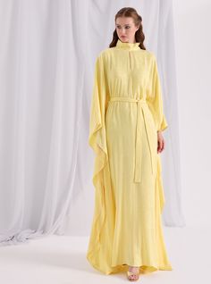 Model height: 177 CM 100% Viscose Length: 140cm Elegant Long Kaftan For Daywear, Chic Long Yellow Dress, Fitted Silk Kaftan For Spring, Yellow Silk Long Sleeve Dress, Long Yellow Daywear Dress, Yellow Long Daywear Dress, Long Yellow Dress For Daywear, Elegant Long Yellow Dresses, Silk Floor-length Daywear Dresses