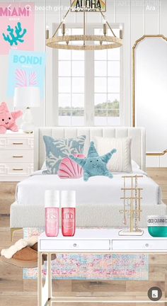 a bedroom with pink and blue accessories on the bed, along with an ocean theme