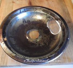 an old metal pan sitting on top of a wooden table