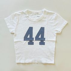 Bnwt Brandy Melville/John Galt White Navy 44 Ashlyn T-Shirt Brandy Melville Number Tee, Brandy Melville Ashlyn Top, Brandy Clothes, Brandy Melville Clothes, Brandy Shirt, 8th Grade Outfits, Brandy Melville Shirts, Brandy Melville T Shirts, Xmas Wishlist