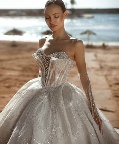 a woman in a wedding dress on the beach