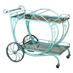 a blue metal serving cart with glass shelves