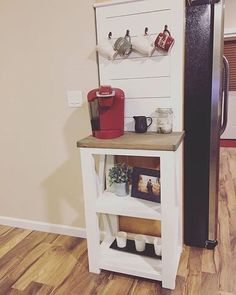 a kitchen area with a refrigerator and coffee maker