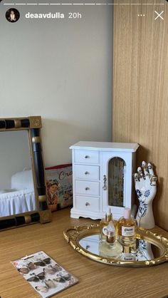 there is a vanity with a mirror and bottles on the table next to each other