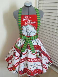 an apron on display in front of a window with the words how the grinch stole christmas