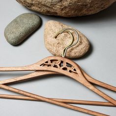 wooden clothes hangers and rocks on a table