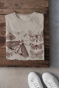 Thanks for stopping by! Moths T-shirt Printed on a super soft, cotton tee Dispatched in 5 working days or sooner Unisex Free UK delivery Material: 100% ringspun cotton. Chest (to fit): S  34/36   M  38   L  40/42   XL  44/46   XXL  48/50 ECO-FRIENDLY Each garment is made to order, reducing extra material and energy that would be otherwise wasted We use DTG printing process which is easier on the environment than screen-printing Our ink is bright and also eco-friendly. Do not tumble dry. Wash at Fairy Grunge Cotton Tops With Crew Neck, Fairy Grunge Crew Neck T-shirt With Screen Print, Fairy Grunge Crew Neck T-shirt Relaxed Fit, Fairy Grunge Relaxed Fit Crew Neck T-shirt, Cotton Fairycore T-shirt With Crew Neck, Cotton Fairycore Crew Neck T-shirt, Fairycore Cotton Crew Neck T-shirt, Crew Neck Cotton T-shirt In Fairycore Style, Cotton Crew Neck T-shirt In Fairycore Style