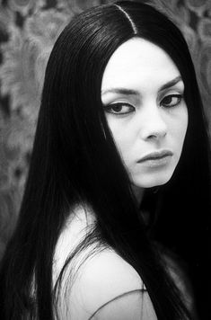 a black and white photo of a woman with long hair