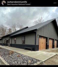 a large metal building with two garages on each side