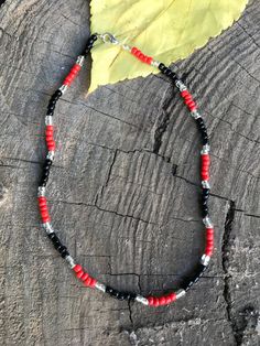 This is a glass seed bead necklace. the beads are 6mm. It is red and black. Adjustable Red Beaded Necklace With Black Beads, Adjustable Red Necklace With Black Beads, Adjustable Red And Black Beaded Necklace, Gift Red Beaded Necklaces With Black Beads, Red Beaded Necklaces With Black Beads For Gifts, Red And Black Beaded Necklaces For Gifts, Gift Red And Black Beaded Necklaces, Red And Black Beaded Necklace For Gift, Red Beaded Necklace With Silver Beads