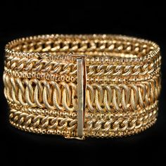 a gold bracelet with two rows of chains and a square clasp on the front of it