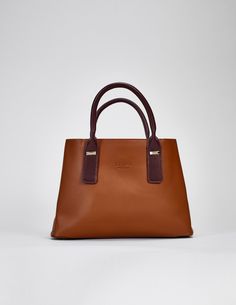 The Cognac Hudson Tote is a luxurious vegan leather bag that is effortlessly stylish and incredibly versatile. It can be used as a shoulder bag or a crossbody bag, depending on the occasion. This multi-way purse is a great choice for those looking to add a touch of sophistication and elegance to their wardrobe. Material: Genuine Soft Vegan Leather Dimensions : 33 L x 14 w x 23 h Pockets: 6 Interior compartments Straps : 2 chocolate brown handles & 1 chocolate brown crossbody strap Locks: 2 snap Timeless Cognac Crossbody Bag, Timeless Brown Satchel With Detachable Strap, Timeless Brown Bag With Detachable Strap, Timeless Cognac Satchel With Detachable Strap, Timeless Cognac Shoulder Bag With Detachable Strap, Timeless Brown Shoulder Bag With Handle Drop, Timeless Cognac Shoulder Bag With Detachable Handle, Timeless Cognac Bag With Detachable Handle, Classic Cognac Shoulder Bag With Detachable Handle