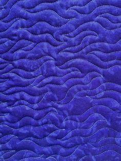 a close up view of a blue quilt