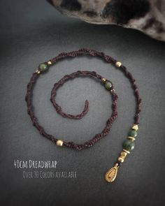 🌱 Hand-knotted macrame dreadwrap with Indian brass teardrop and brass beads. Choose from over 30 yarn colors and various semi-precious stone beads. Length of a dread approx. 40 cm, thickness approx. 4-5 mm. The yarn is Brazilian Linhasita knotting yarn. This is waterproof, tear-resistant, colorfast and very durable. The beads are made of Indian brass and are completely waterproof, rust-free and nickel-free (please follow the care instructions for brass). In order to enjoy the hair accessory for a long time, it is recommended to avoid contact with (salt) water and to take off the dread when going to bed. Yay! The dread is suitable for both dreadlocks and normal hair! The dread is attached either with a loop that is wound double or triple around a real dread or in normal hair with a clip-in Artisan Hand Knotted Adjustable Jewelry, Spiritual Macrame Jewelry For Crafting, Macrame Jewelry With Waxed Cord And Round Beads, Bohemian Braided Jewelry As Gift, Bohemian Braided Jewelry Gift, Adjustable Hand Knotted Jewelry For Festivals, Bohemian Waxed Cord Beaded Jewelry, Bohemian Braided Jewelry For Festivals, Adjustable Braided Bohemian Jewelry