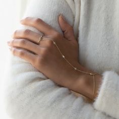 Dainty and minimal, but never understated. This handchain bracelet is made with five tiny pave crystals linked to a delicate chain that shimmers with every move. Comfortable to wear for long periods, you'll never want to take this off! Thick layer of 14K Gold over Sterling Silver Cubic Zirconia pave crystals, 3mm Hypoallergenic, lead and nickel free Wrist Chain Length: 5.75-6.75in (14.6-17cm), 6.75-7.75in (17-20cm) Palm Chain Length: 4in (10.2cm) Handcrafted in NYC #B298 2-3 Business Days Delicate Chain Ring, Hands Full Of Bracelets, Classy Hand Rings, Hand Rings Simple, Cheap Elegant Hand Wrapped Jewelry, Hand For Jewelry, Rose Gold Stackable Rings, Wrist Chain, Hand Chain Jewelry