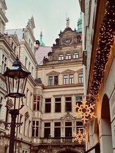 an old building with christmas lights hanging from it's sides