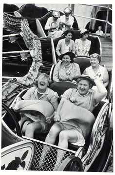 an old black and white photo of people riding on roller coasters