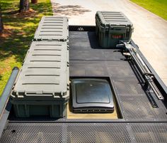 there are two coolers sitting on the back of a truck