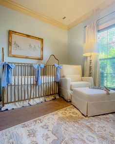 a baby's room is decorated in white and blue