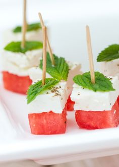 watermelon and mozzarella skewers with toothpicks on a white plate