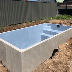 an unfinished concrete pool in the middle of a construction area with dirt on the ground