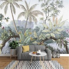 a living room scene with a couch, table and tropical wall mural on the wall