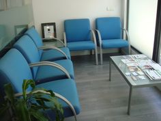 a room with blue chairs and a coffee table