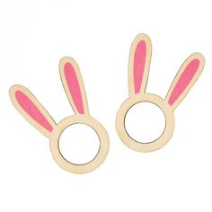 two wooden bunny ears are shown in pink