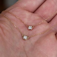 * .167 carats (3.5mm) diamond, SI2, G-H, 100% conflict free * 14k yellow gold or rose gold * 18 inch chain A gorgeous, round brilliant diamond is set entirely in 14k gold and hung in the center of a 14k gold chain in this solitaire necklace. You can choose between 14k yellow gold and 14k rose gold. The diamond is .167 carats (1/6 carat), SI2, G-H in color, and 100% ethical and conflict free. The diamond pendant measures 4.6mm across and the total length of the necklace is 18 inches. This necklac