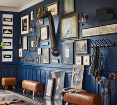 a living room with blue walls and pictures on the wall