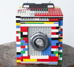 an old camera made out of legos is shown in black and white with three different pictures