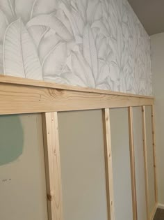 an unfinished room with white walls and wood framing on the bottom part of the wall