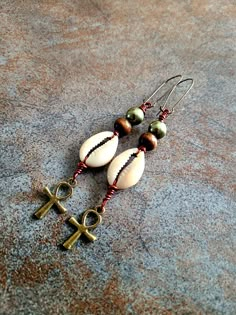 "Cowrie Shell Bronze Ankh Earrings, Sea Shell Earrings, Agate Stone, Brown Wire, Sea Shell Earrings Cowrie shell earrings can easily become your favorite pair. 2\" length, Bronze kidney wires, Agate gemstones. Still shopping? Wonderful. www.etsy.com/shop/KheperaAdornments *Customer service is my greatest priority*" Handmade Ankh Earrings As Gift, Ankh-shaped Earrings For Pierced Ears As Gift, Handmade Adjustable Ankh Earrings, Ankh Earrings, Cowrie Shell Earrings, Cowrie Shell Jewelry, African Inspired Jewelry, Sea Shell Earrings, Earthy Earrings