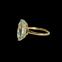 an image of a ring that is made out of gold and aqua blue topazte