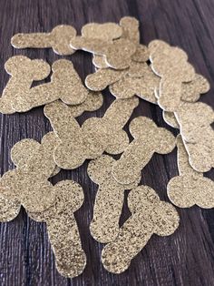 some gold glitter hearts on a wooden table