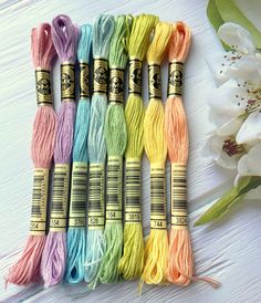 six skeins of multicolored yarn sitting next to each other on a table