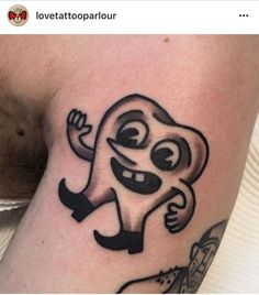 a cartoon character tattoo on the thigh