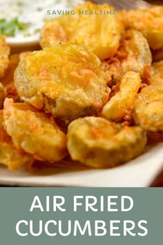 air fried cucumbers on a white plate with ranch dip and sour cream in the background